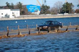 Car driving on a flooded roadway